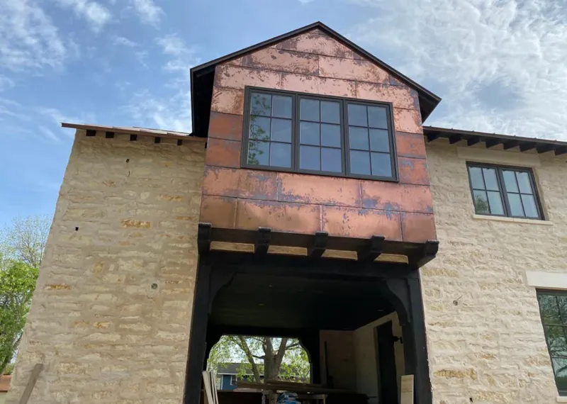 Copper metal panel facade on a stone building for Skylight Installation in Mission Bend